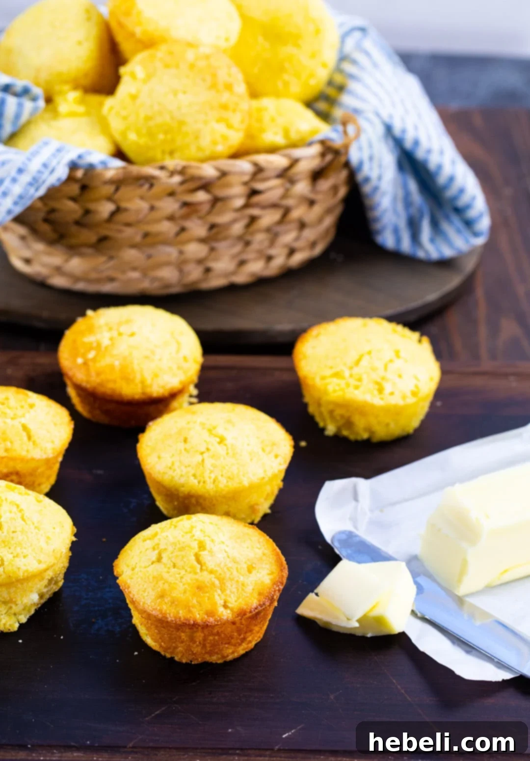 Golden Boston Market Sweet Cornbread 3 Fluffy Boston Market Style Cornbread muffins on a wooden board, served with a stick of butter.