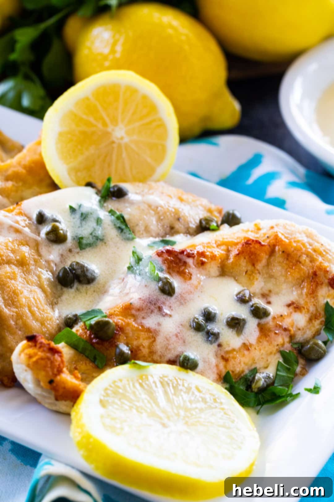 Zesty Lemon Butter Chicken 3 A close-up shot of Lemon Butter Chicken with Capers on a white plate, ready to be served, garnished with fresh herbs.