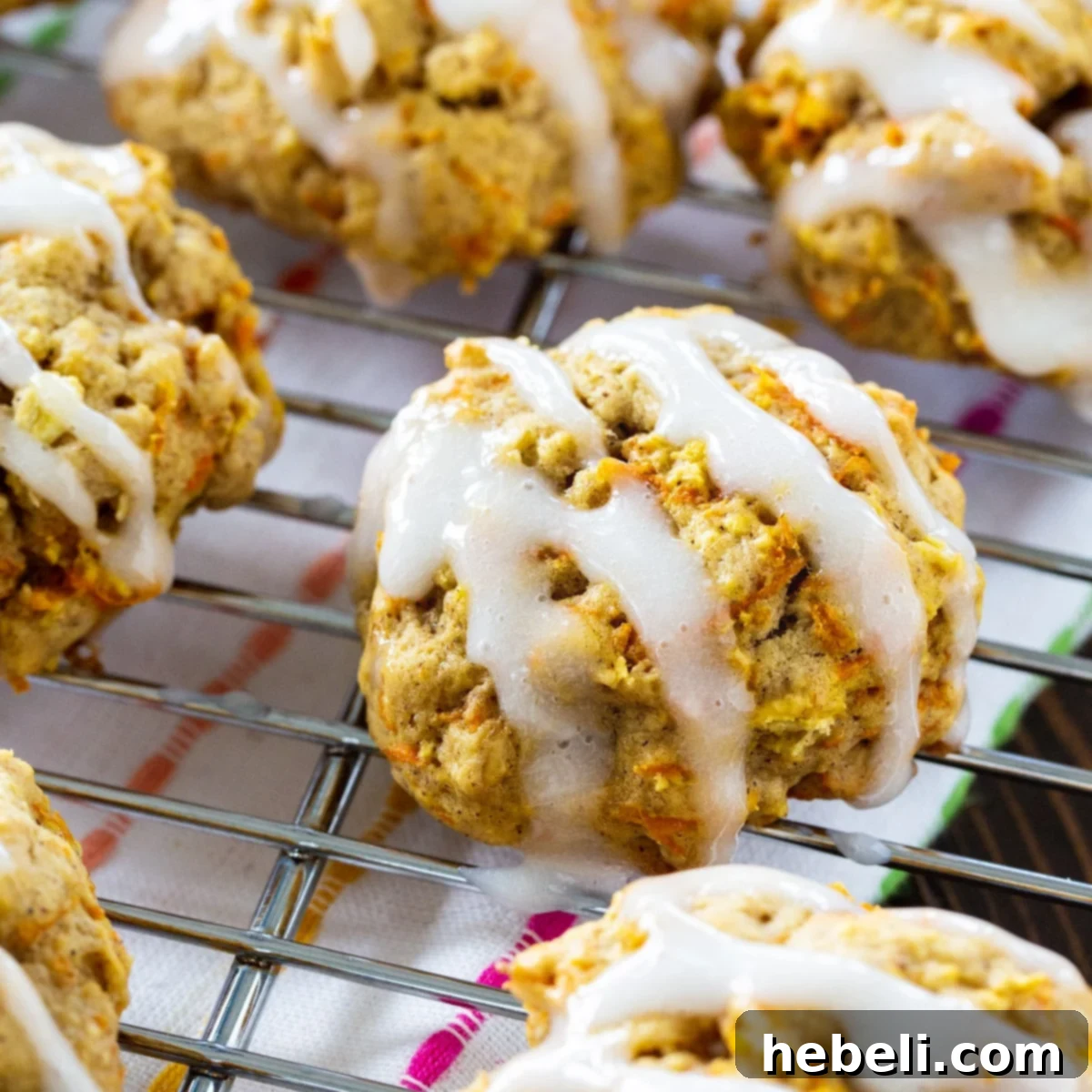 Delicious Carrot Cake Cookies arranged beautifully on a wire rack, some drizzled with sweet sour cream glaze, perfect for a spring or fall dessert.