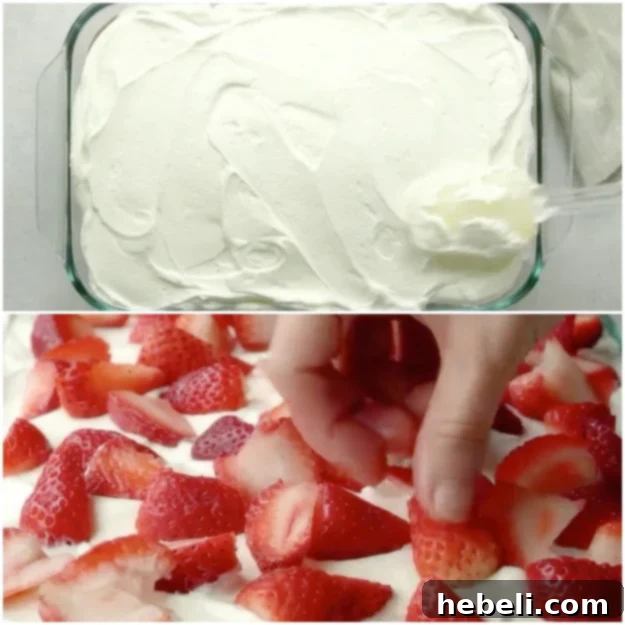 Spreading whipped cream on the cake and topping with fresh strawberries