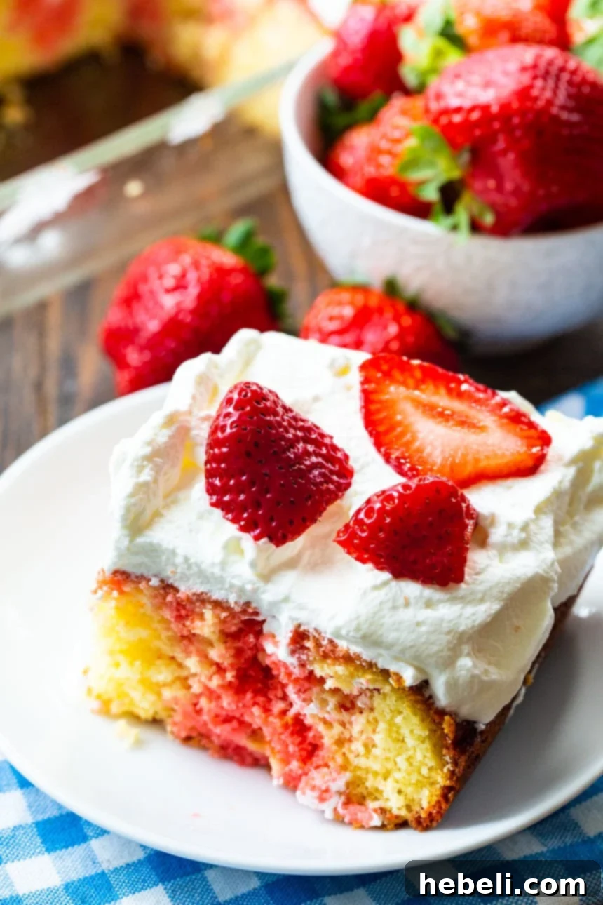Beautifully decorated Easy Strawberry Poke Cake ready to serve