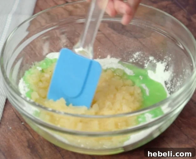 A visual guide showing crushed pineapple and dry pistachio pudding mix being stirred together in a bowl until the mixture is smooth and evenly combined.