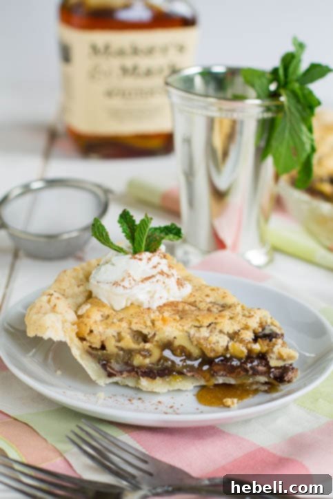 Close-up of a perfectly baked slice of Thoroughbred Pie, showcasing its gooey chocolate and walnut layers