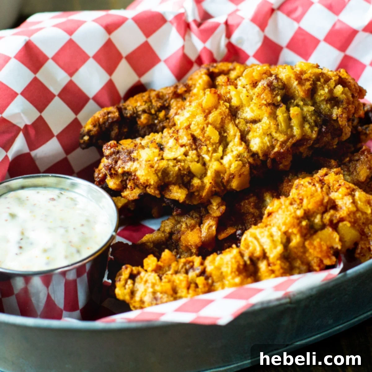 Crispy Chicken Fried Steak Fingers in a rustic basket, ready to be dipped in a side of golden Creole mustard sauce.