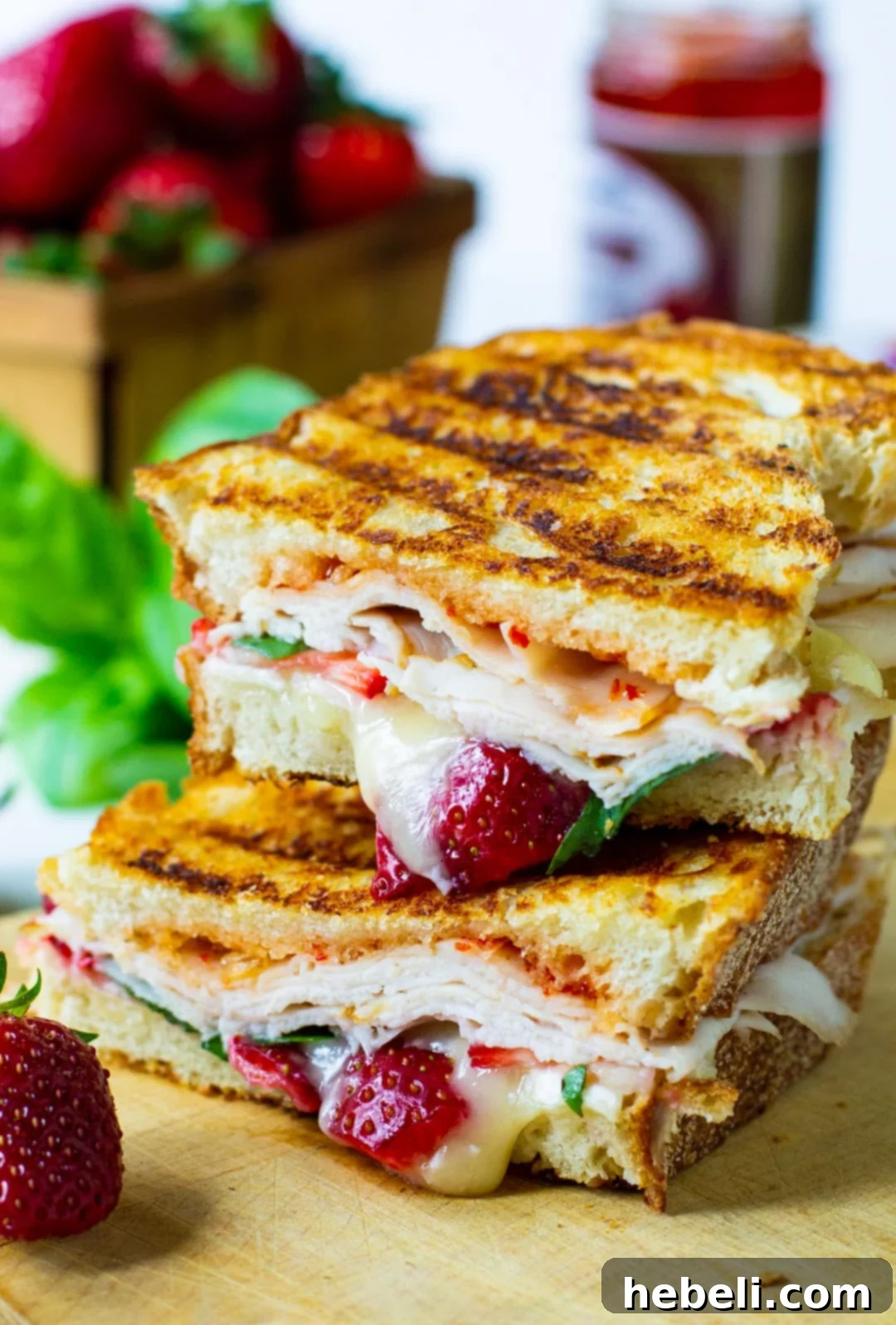 Turkey Panini cut in half and stacked, showing the melted brie and fresh ingredients.