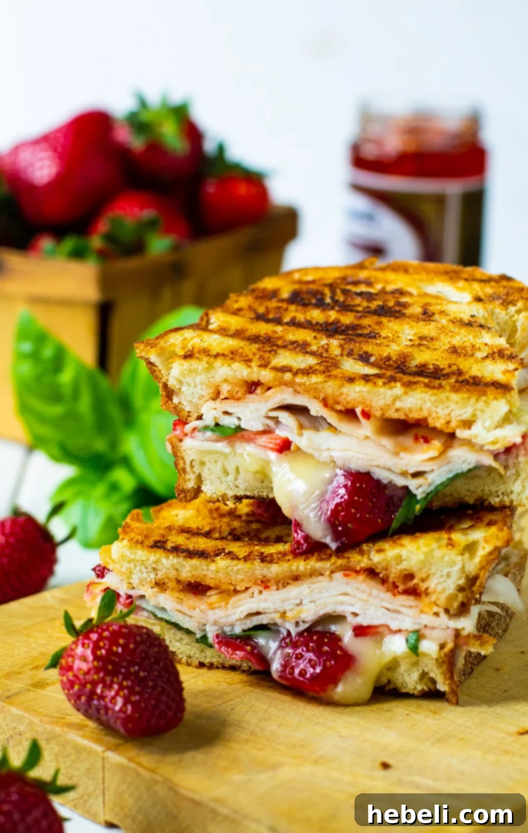 Strawberry, Brie, and Turkey Panini neatly arranged on a cutting board, ready to be served.