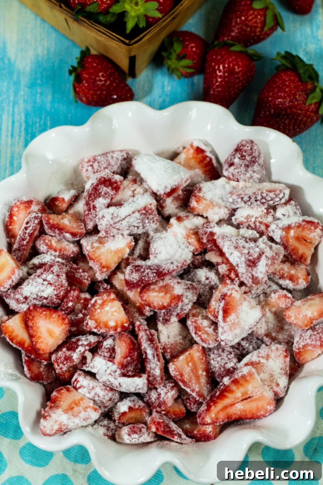 Strawberry filling prepared in a pie plate before being topped with biscuit dough and baked.