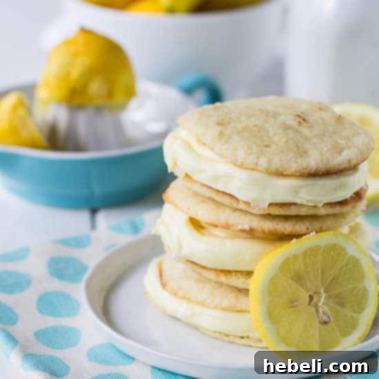 Zesty Lemon Whoopie Pies 2 Bright and refreshing Lemon Whoopie Pies stacked on a white plate, ready to be enjoyed.