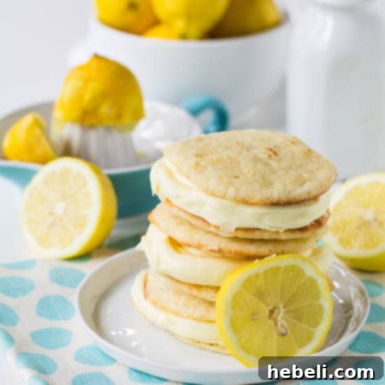 Zesty Lemon Whoopie Pies 5 A close-up of a Lemon Whoopie Pie cut in half, revealing the thick, creamy lemon filling.