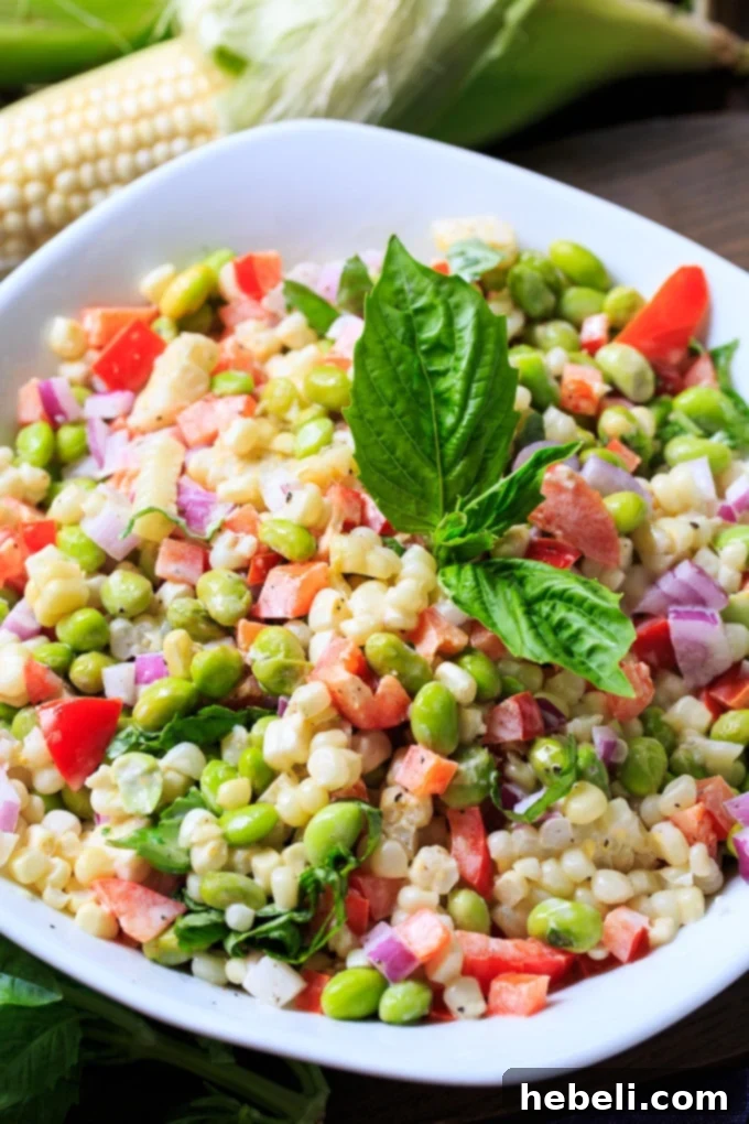 Vibrant Roasted Corn and Edamame Salad 4 Hands shucking perfectly roasted corn on the cob, showing how easy it is.
