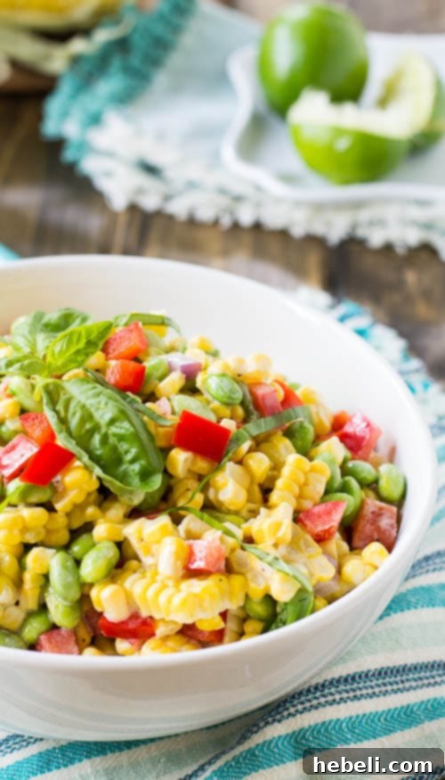 Vibrant Roasted Corn and Edamame Salad 6 Close-up of a vibrant Roasted Corn Edamame Salad, garnished with fresh herbs and a hint of spice.