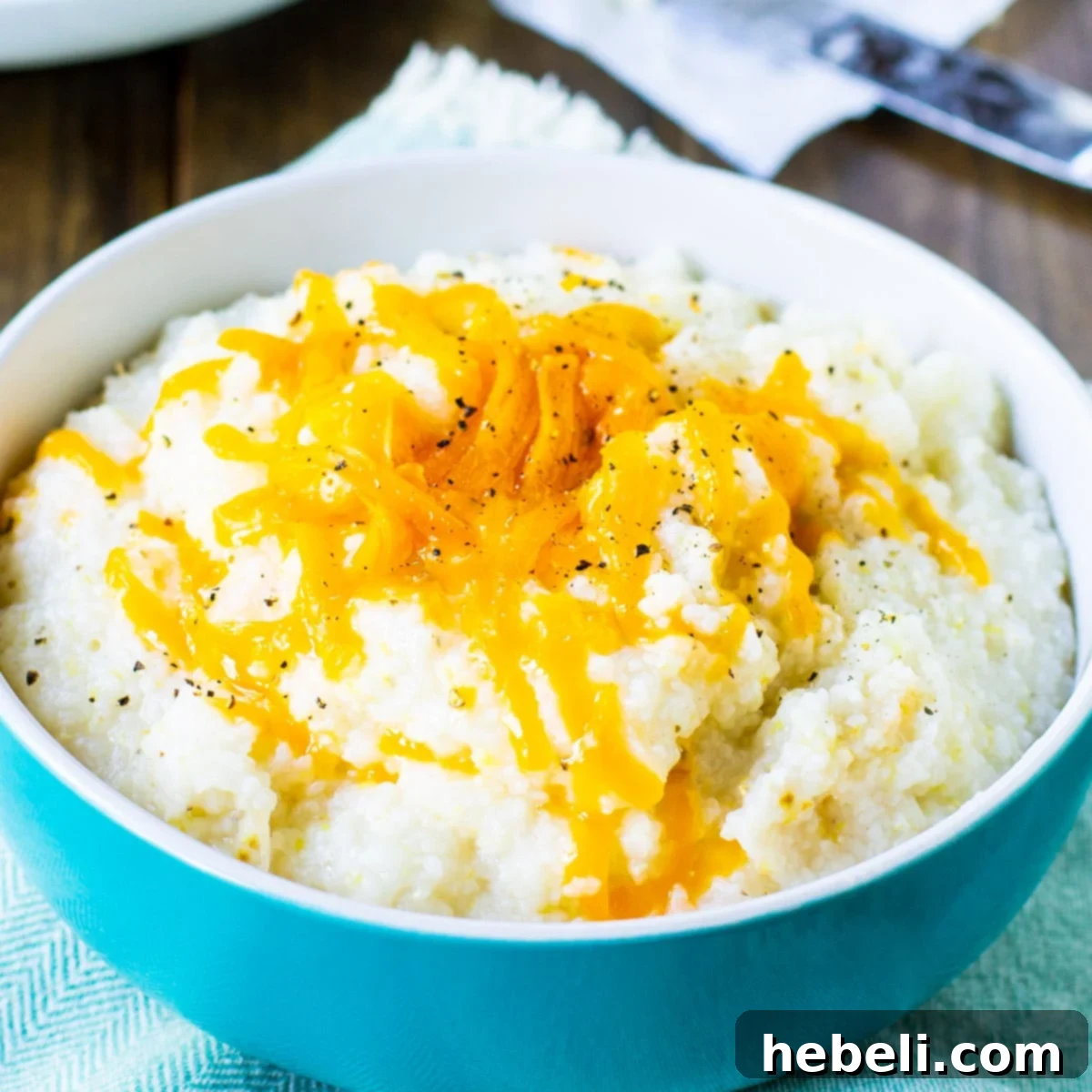 A bowl full of creamy crockpot grits, ready for breakfast.