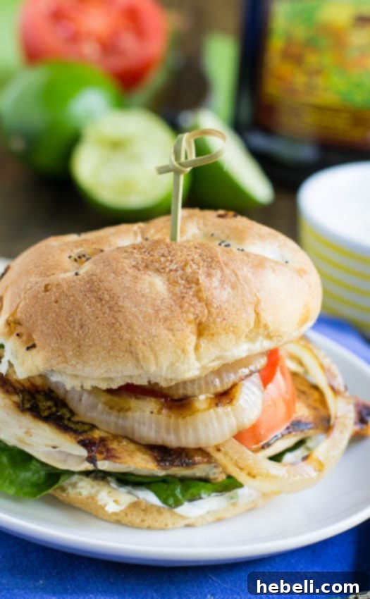 Fresh Mojito Chicken Sandwiches 4 Close-up of three Mojito Chicken Sandwiches stacked, showing the layers of chicken, onion, lettuce, and tomato.