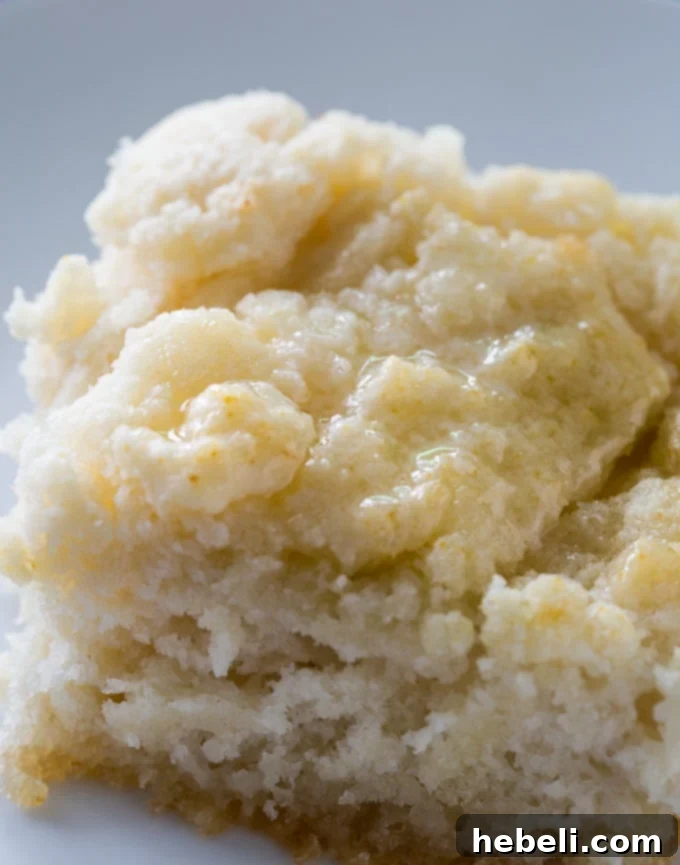 Sticky 7-Up biscuit dough being gently pressed into a baking pan