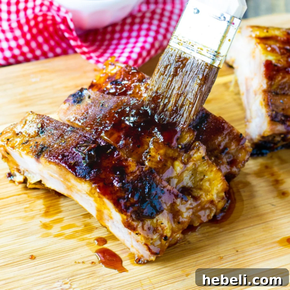 Brushing the rich, homemade Jack Daniel's BBQ sauce onto perfectly grilled ribs.