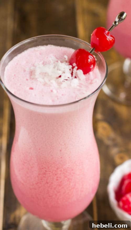 Close-up of a Pink Coconut Frost Cocktail with garnishes
