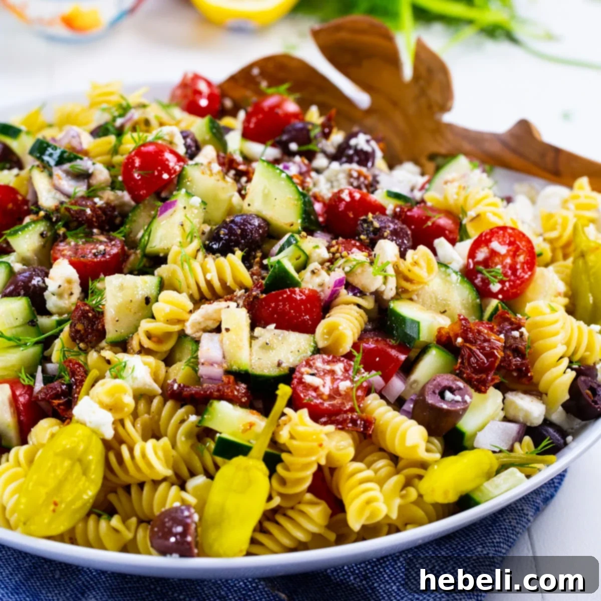 Zesty Greek Pasta Salad 2 Delicious Greek Pasta Salad served in a large, elegant bowl, ready for sharing.