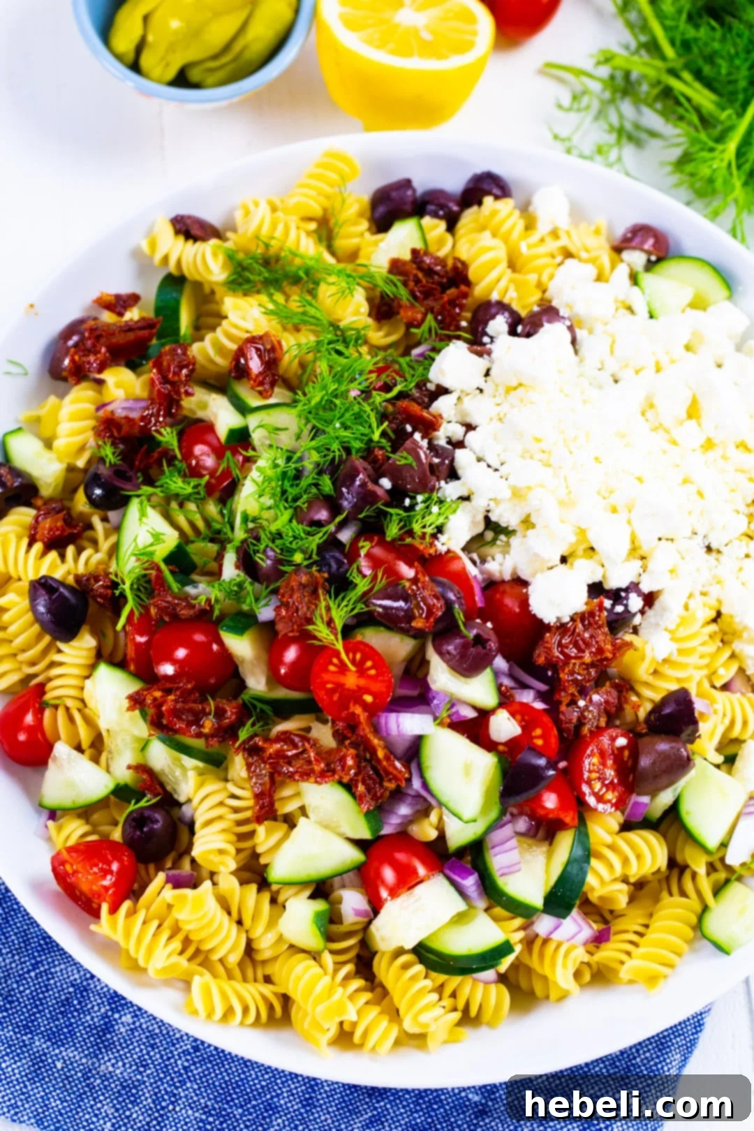 Zesty Greek Pasta Salad 4 Unmixed Greek Pasta Salad ingredients in a bowl, showing fresh vegetables and pasta.