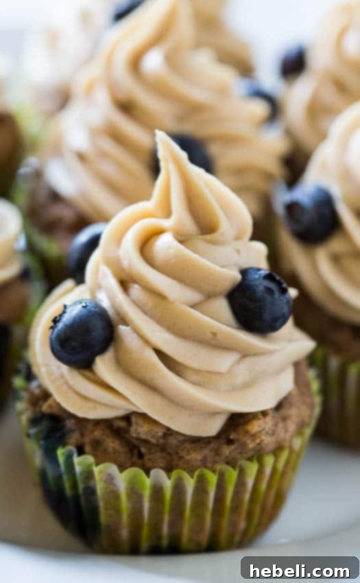 Luscious Blueberry Maple Cupcakes 3 Top-down view of freshly baked Blueberry Maple Cupcakes, richly frosted and ready to enjoy