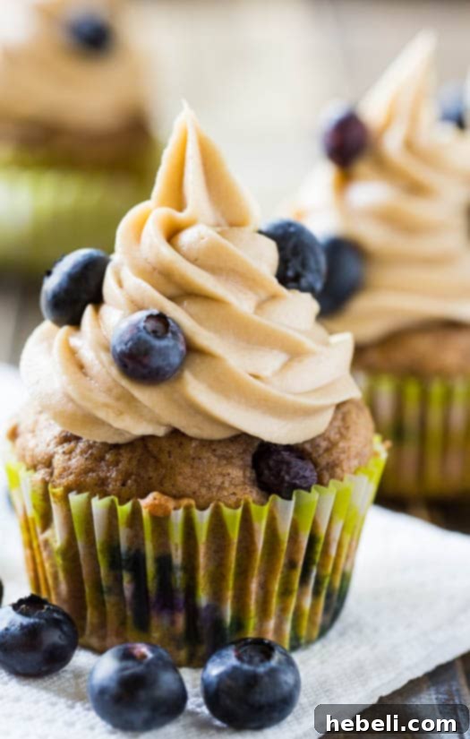 Luscious Blueberry Maple Cupcakes 8 A stack of three Blueberry Maple Cupcakes, revealing the moist interior and vibrant blueberries within each layer