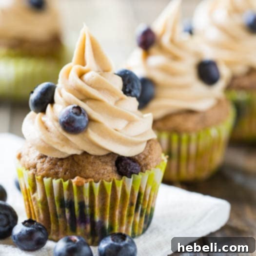 Close-up of Blueberry Maple Cupcakes artfully decorated with fresh blueberries, ready for a photo shoot or serving
