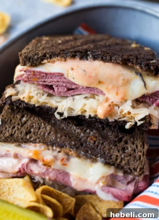 Reuben with a Kick 4 A pair of exquisitely grilled Spicy Reuben sandwiches, perfectly assembled with golden-brown rye bread, savory corned beef, melted Swiss cheese, and tangy sauerkraut, arranged for a mouth-watering presentation.