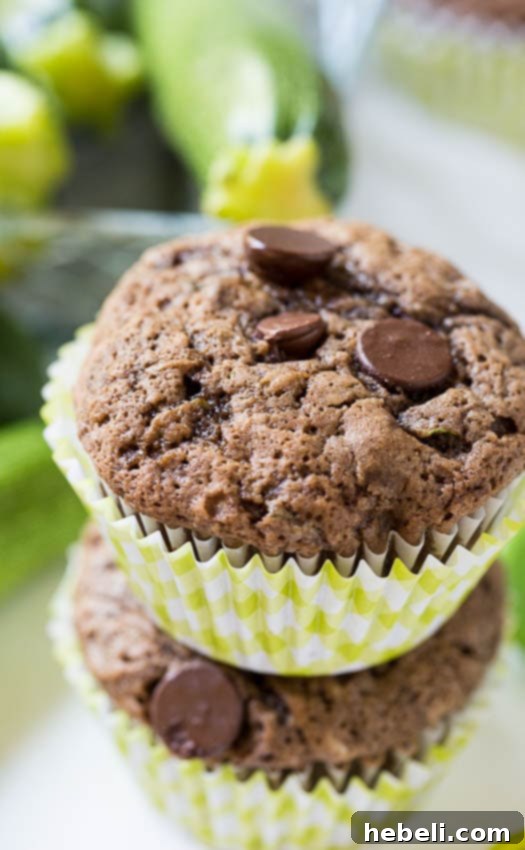 A selection of dark chocolate zucchini muffins on a cooling rack