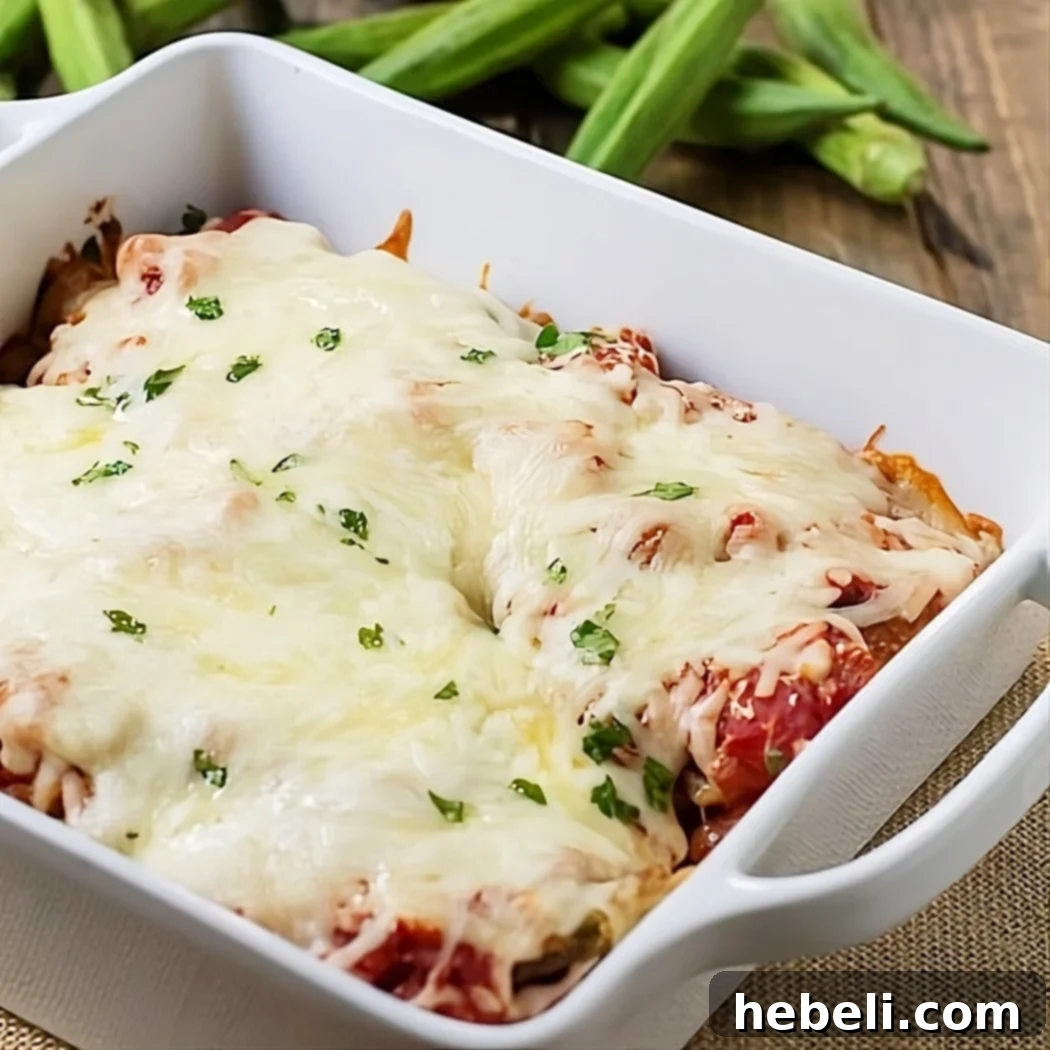 Classic Okra Parmigiana Bake 2 Golden brown Okra Parmigiana in a baking dish, fresh from the oven, with melted cheese and rich tomato sauce.