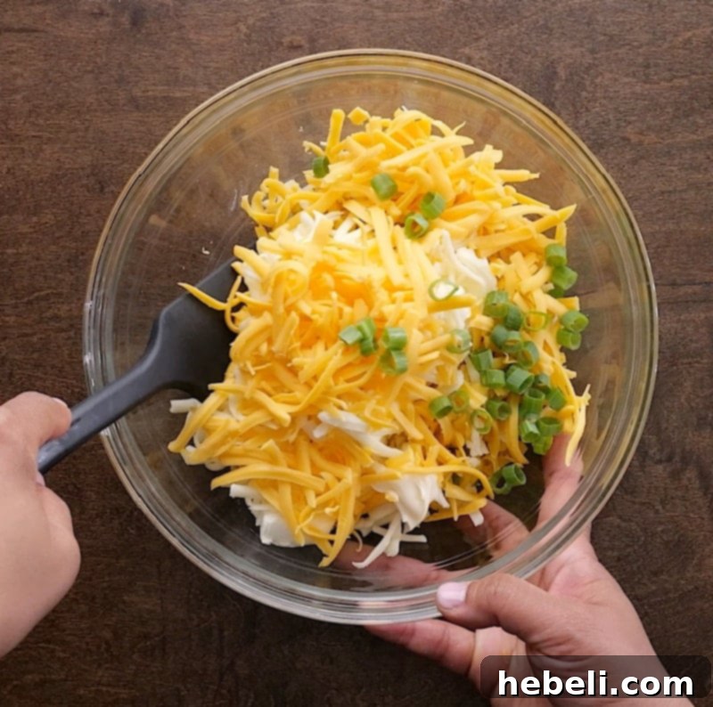 Mixing all the creamy and cheesy ingredients with the corn mixture in a large bowl.