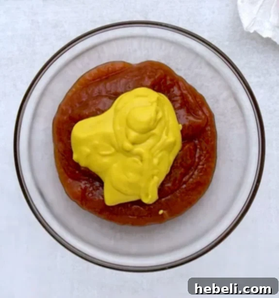 A bowl of red and yellow sauce, ingredients for the special cheeseburger pizza sauce.