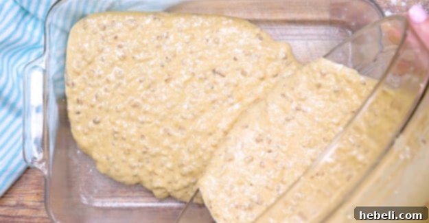 Tropical Hummingbird Poke Cake 3 Cake batter being poured into a baking pan.