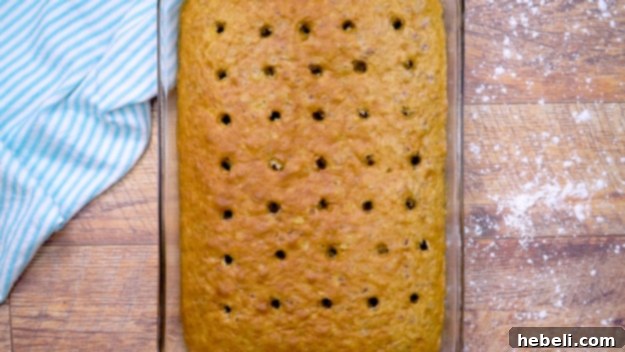 Tropical Hummingbird Poke Cake 4 Cake with evenly spaced holes poked into its surface.