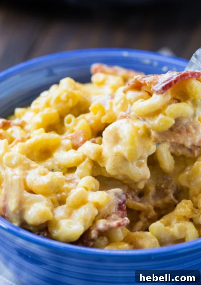 Creamy Mac and Cheese with bacon made in the crock pot, ready to serve.