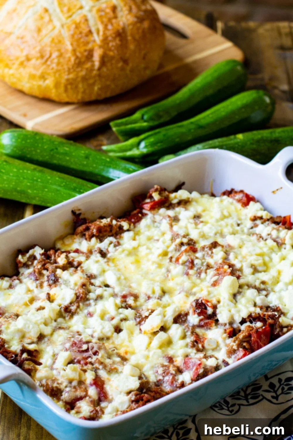 Creamy Zucchini Moussaka 4 A delicious Zucchini Moussaka with a loaf of crusty bread on the side, ready for a family meal.