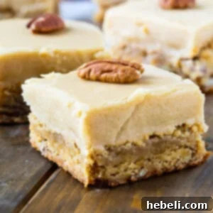 Butterscotch Blondies cut into squares with whole pecans on top.