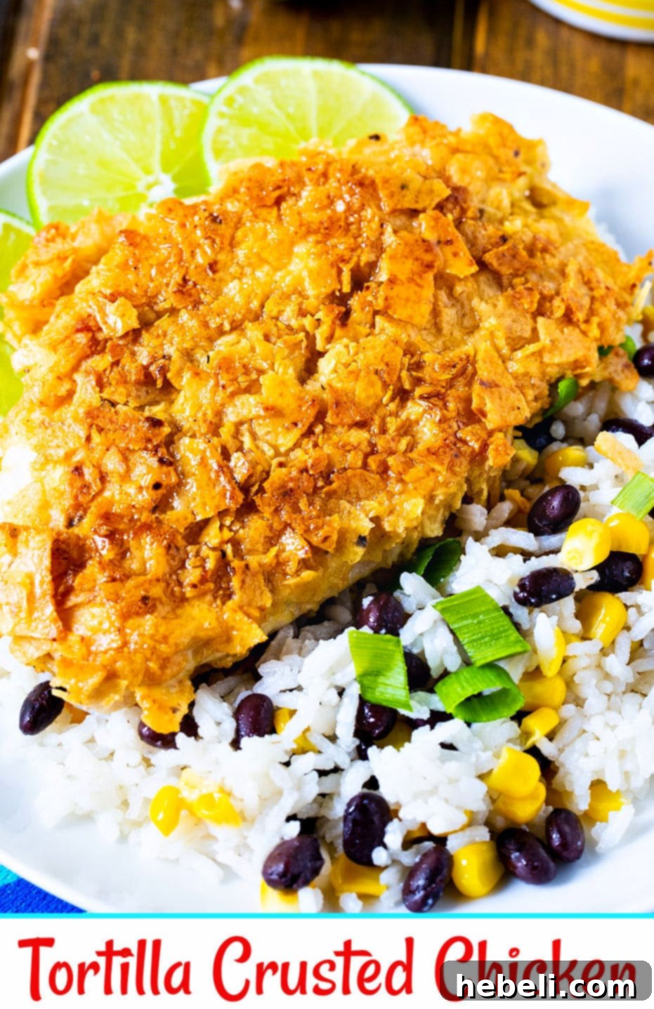 A close-up of a serving of Tortilla Crusted Chicken with Coconut Rice, black beans, and corn, beautifully plated.