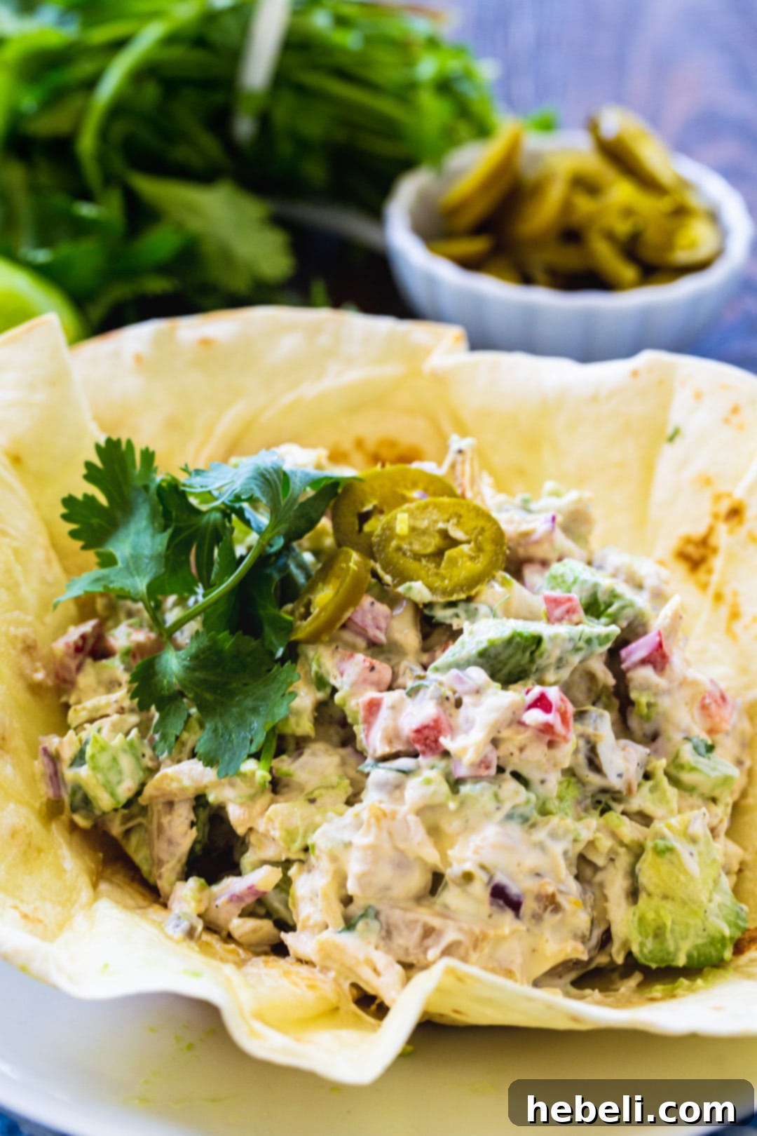Bold Jalapeno Chicken Salad 4 A close-up shot of the delicious Jalapeño Chicken Salad in a perfectly crispy flour tortilla shell, showcasing its creamy texture and vibrant ingredients.