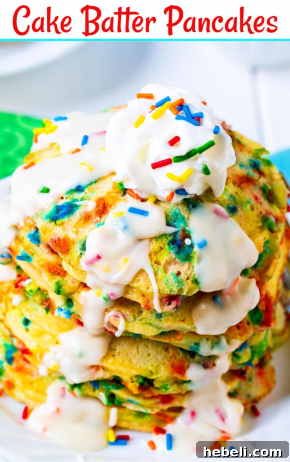 A close-up of a single Cake Batter Pancake on a small white plate, showing the texture and sprinkles, with glaze