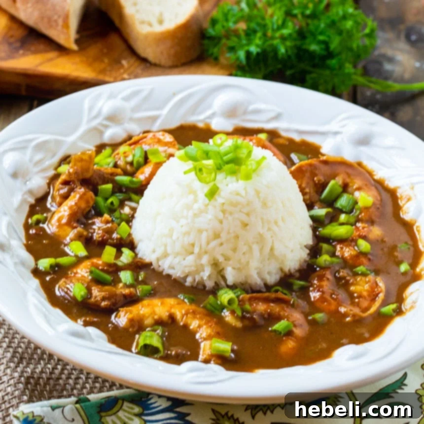 Classic Shrimp Etouffee, rich and vibrant, served over a bed of white rice in a rustic bowl.