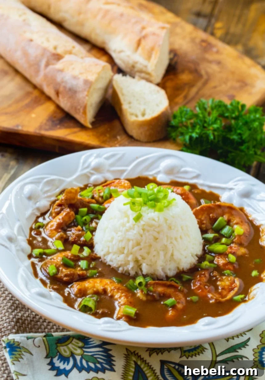 A bowl of rich Shrimp Etouffee with French bread on the side, ready to be enjoyed.