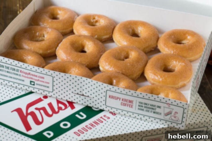 A stack of classic Krispy Kreme glazed donuts, ready for transformation.