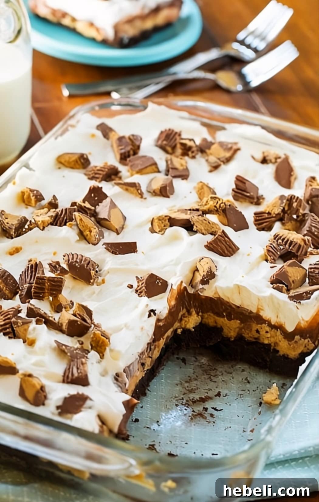Decadent Peanut Butter Chocolate Stack 3 A baking pan filled with Chocolate Peanut Butter Lush, with one square already removed, revealing the delightful layers.