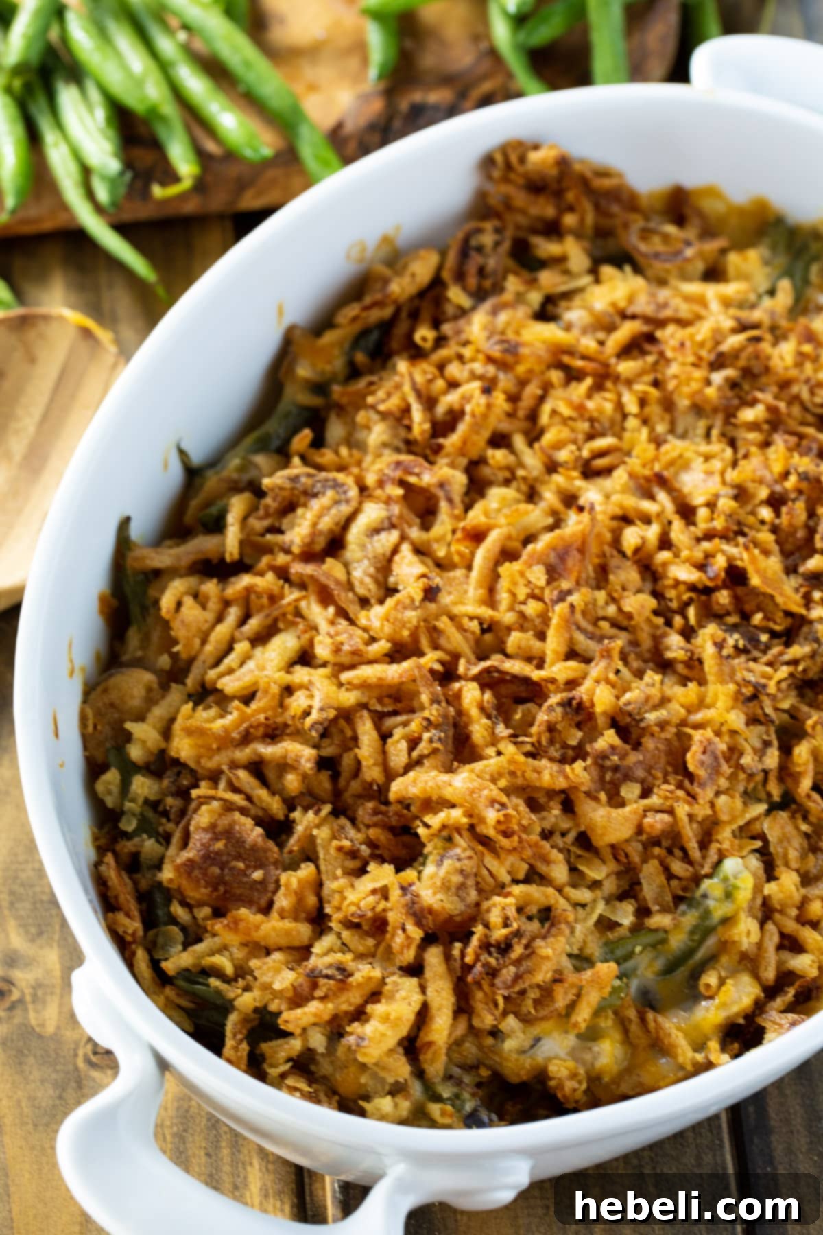Mouthwatering Cheesy Green Bean Bake 3 Close-up of Cheesy Green Bean Casserole with a crispy French-fried onion topping.