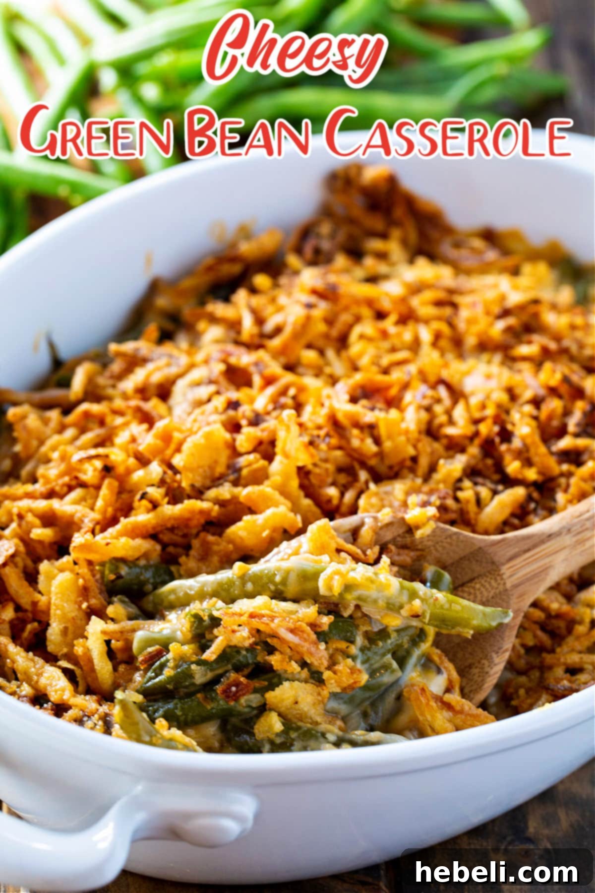 Mouthwatering Cheesy Green Bean Bake 4 A serving spoon lifting a portion of Cheesy Green Bean Casserole from a dish, showing its creamy texture and crispy topping.