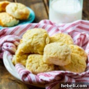 Close-up of a stack of golden, flaky Callie's Buttermilk Biscuits, showcasing their perfect rise.