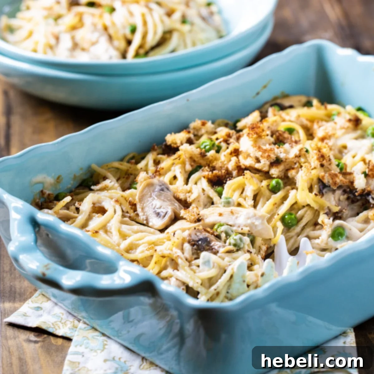 Comforting Turkey Tetrazzini Casserole 2 Turkey Tetrazzini in a blue casserole dish, ready to be served.