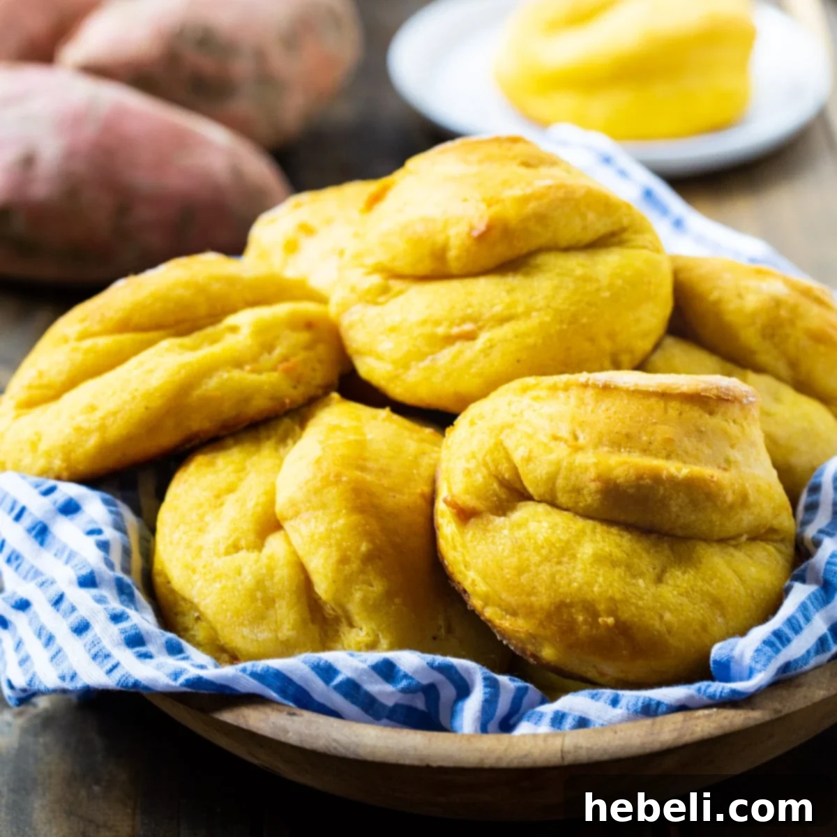 Homemade Sweet Potato Rolls piled high in a rustic basket, ready to be served.