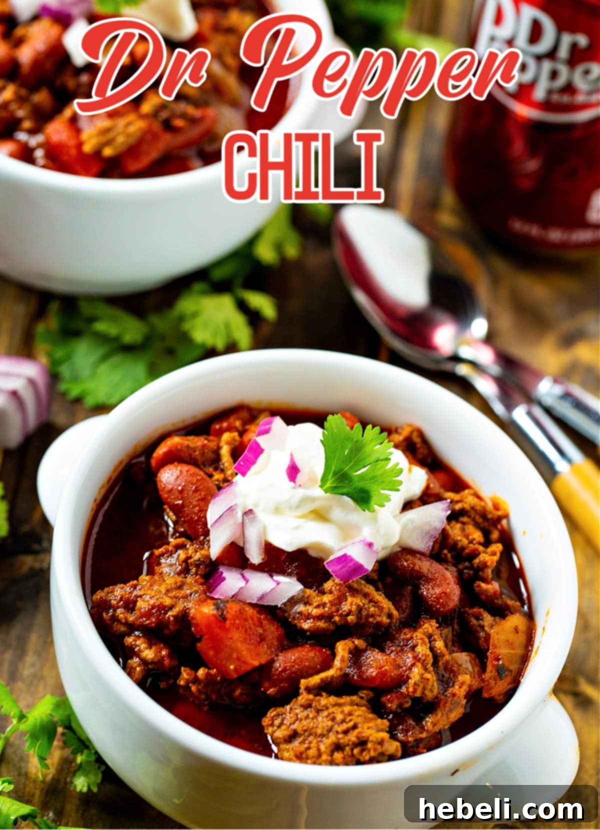 A close-up view capturing the rich, thick, and inviting texture of Dr Pepper Chili in a rustic bowl.
