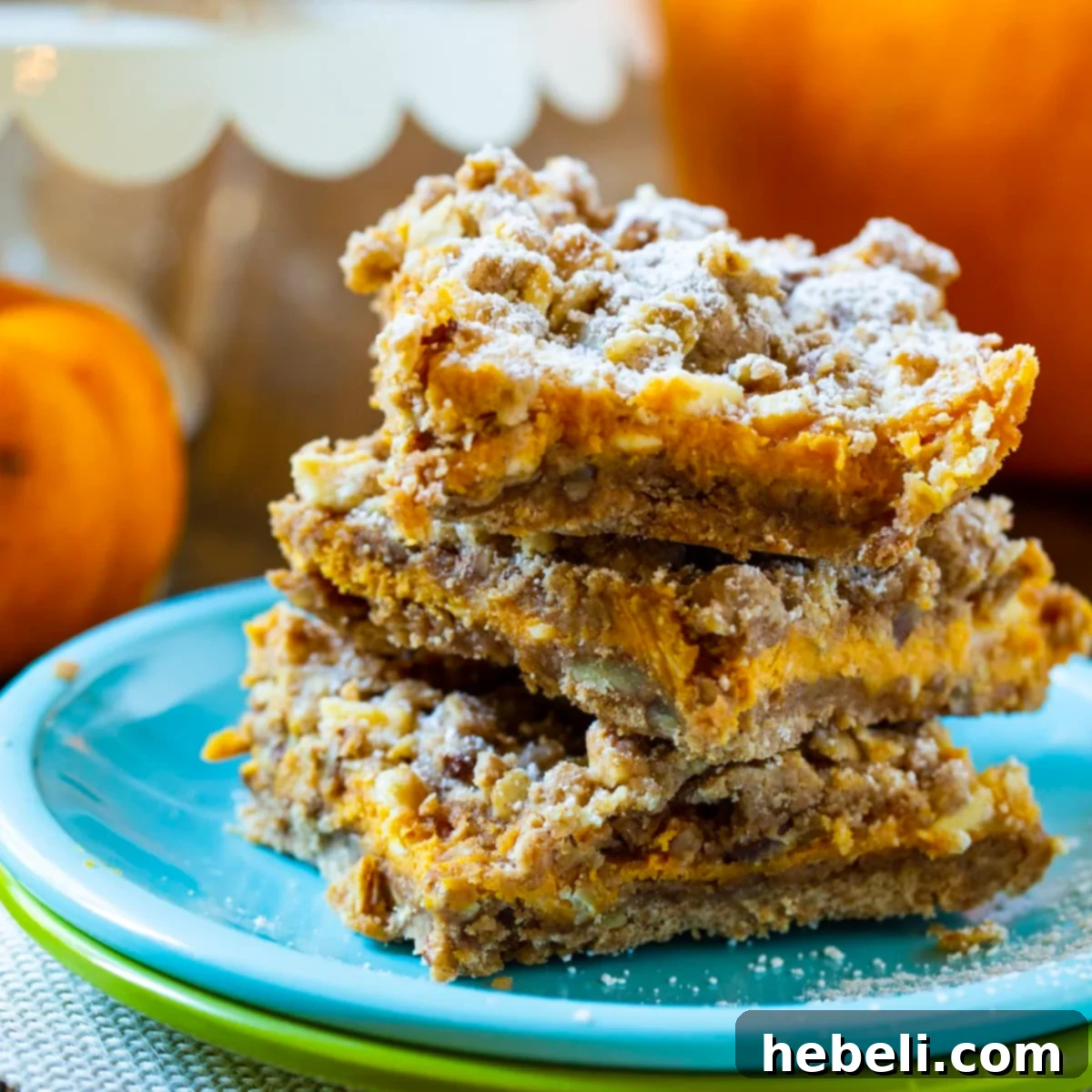 Harvest Pumpkin Spice Bars 2 Stacked Pumpkin Spice Bars on a decorative plate, showcasing the layers.