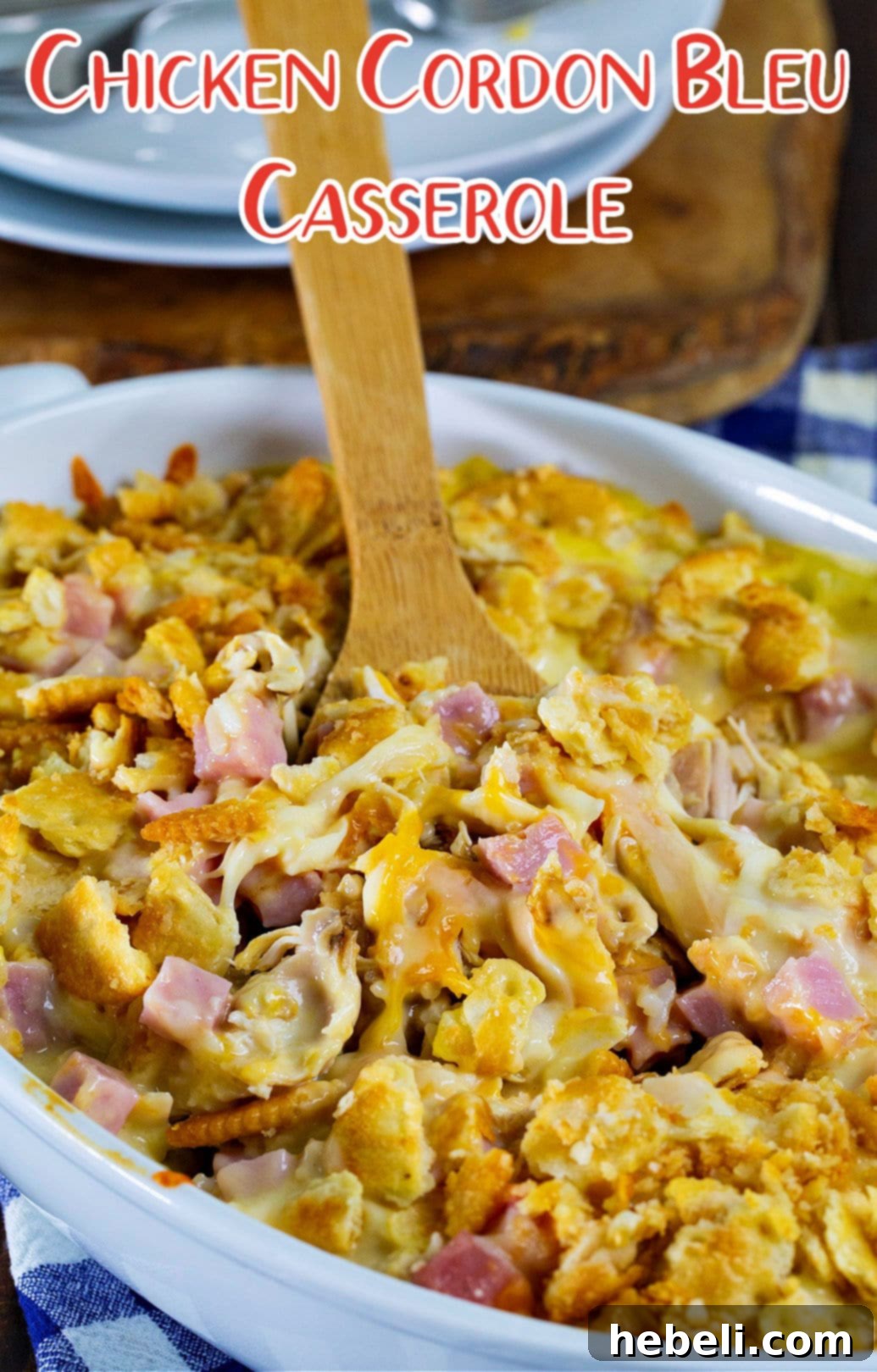 Creamy Chicken Cordon Bleu Bake 5 A serving of Chicken Cordon Bleu Casserole with a spoon, highlighting the creamy sauce and crispy topping.